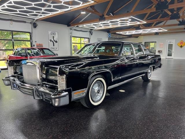 1978 Lincoln Continental Town Car — black with white wall tires in showroom