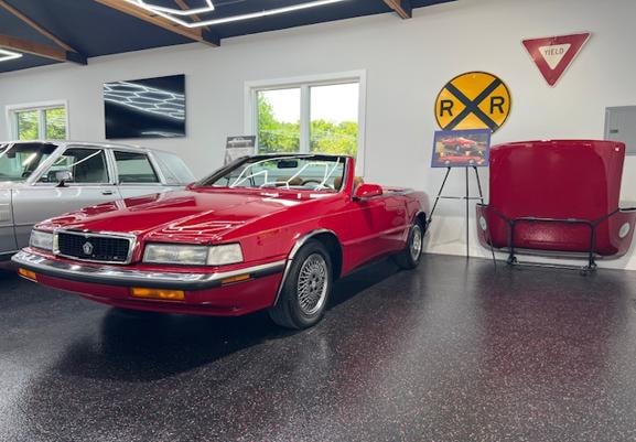 1989 Chrysler TC by Maserati — red convertible in showroom garage