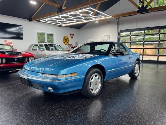 1991 Buick Reatta coupe in modern garage showroom